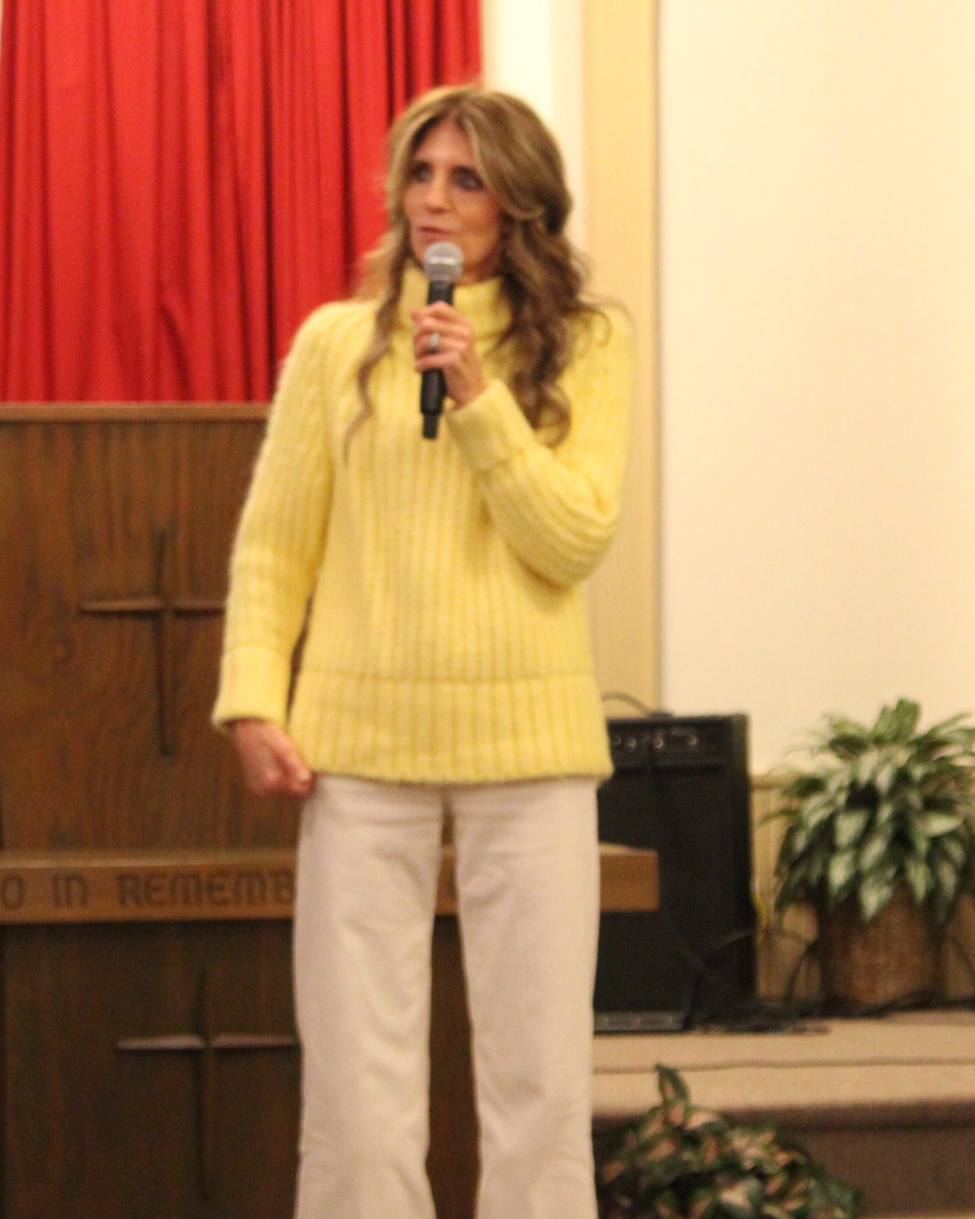 Pastor Mary Pody ministering with a microphone